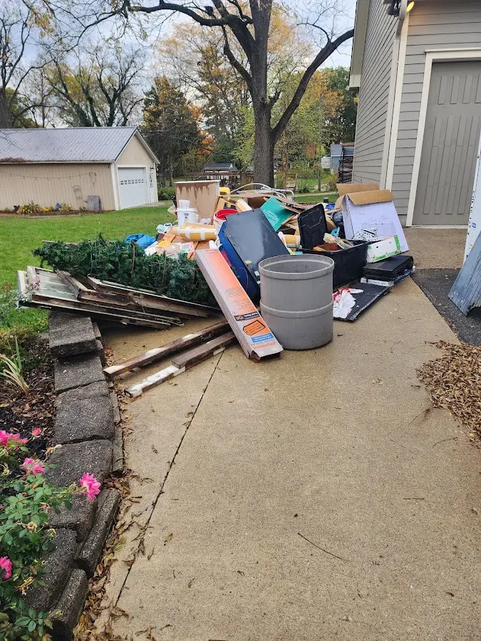 Dumpster being loaded with debris for Residential Dumpster Rental in Greenacres